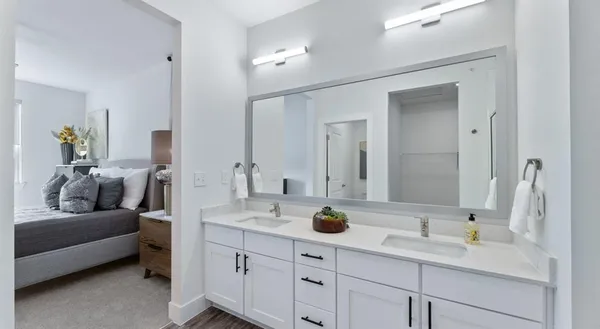 a en suite bathroom with double sink and a mirror