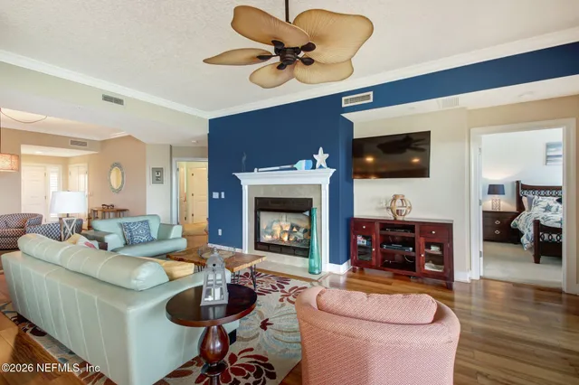 a living room with furniture a flat screen tv and a fireplace