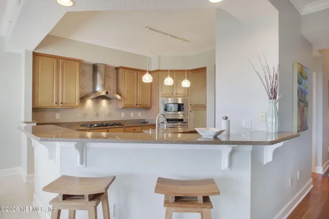 a kitchen with granite countertop a sink and a cabinets