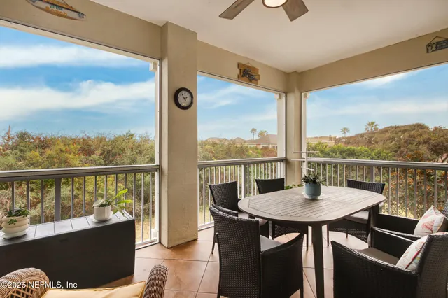 a bedroom with a bed a flat screen tv and a window