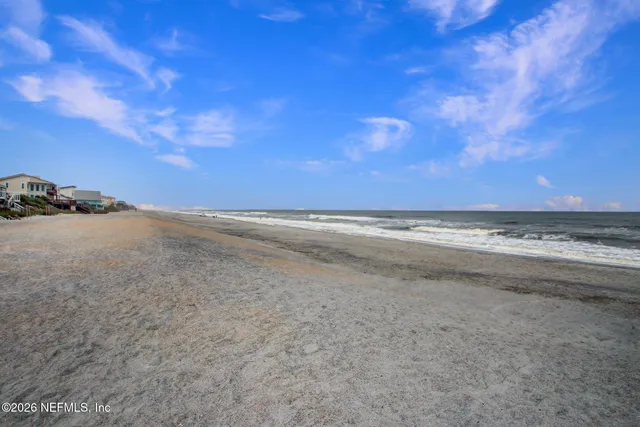 a view of a tennis ground with large trees