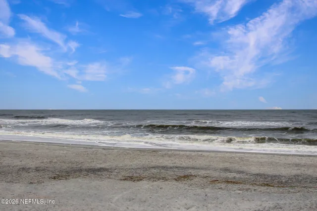 a view of a tennis ground with large trees