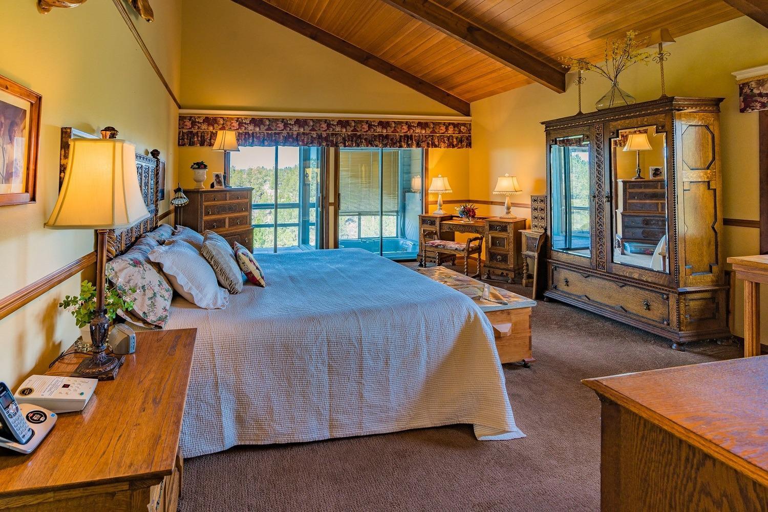 65035 Hopper Road Bend, OR 97703 - Photo 11 of 21 a bed room with a bed and a chair