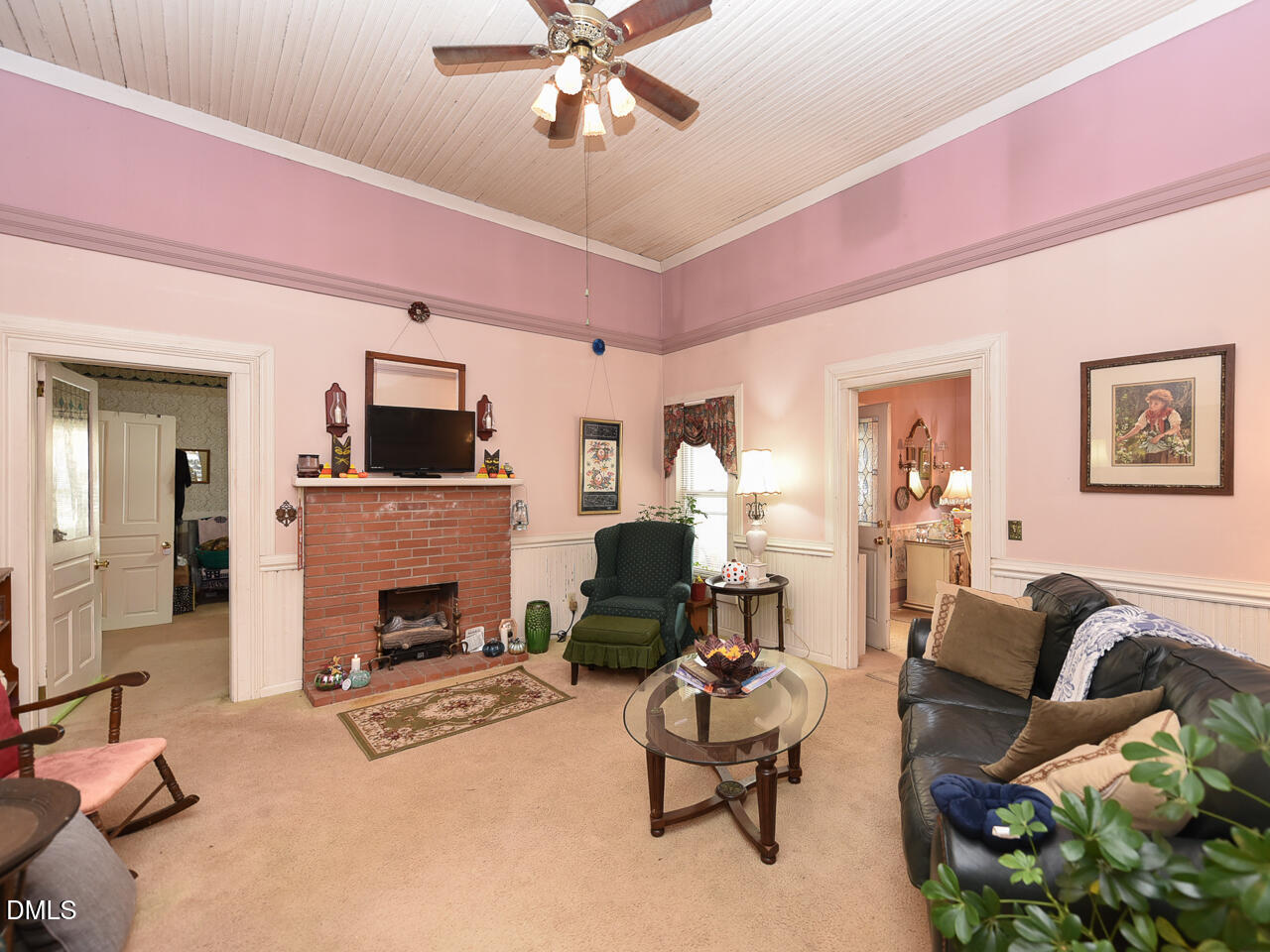 314 West Main Street Benson, NC 27504 - Photo 18 of 30 a living room with furniture a fireplace and a flat screen tv