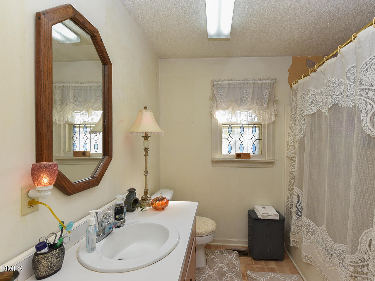 314 West Main Street Benson, NC 27504 - Photo 22 of 30 a bathroom with a sink mirror and window