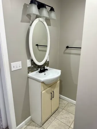 a bathroom with a sink and a mirror