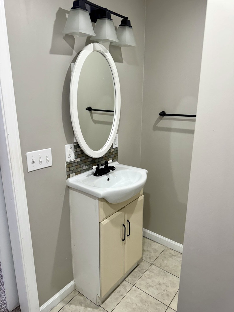 56 May Avenue Buncombe, IL 62912 - Photo 13 of 25 a bathroom with a sink and a mirror