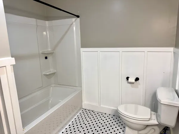 a bathroom with a toilet and a shower
