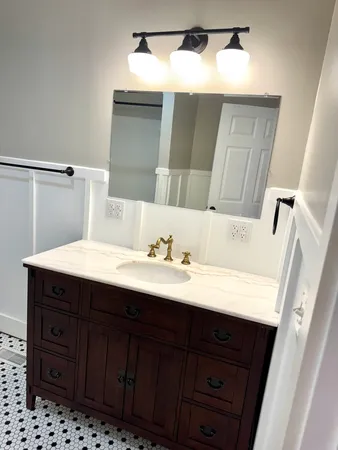 a bathroom with a sink and a mirror