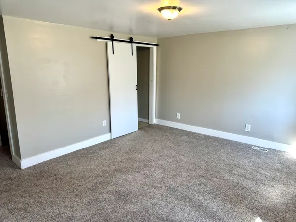 an empty room with closet area