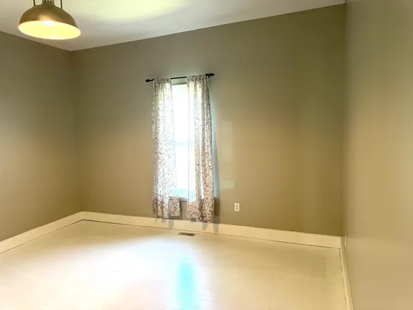 an empty room with a empty space and a window