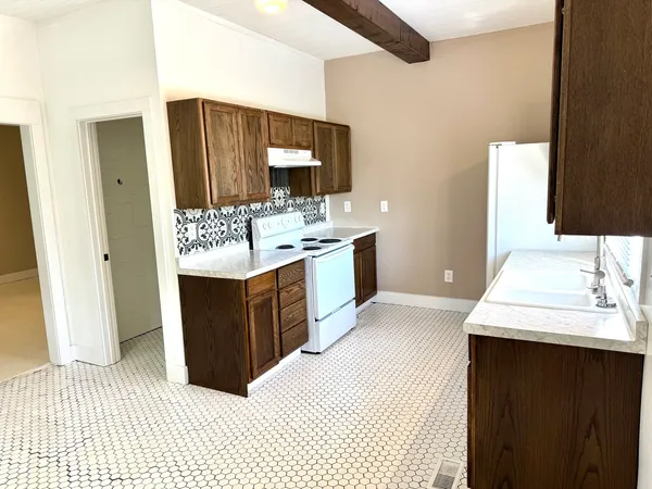 a kitchen with a stove and a sink