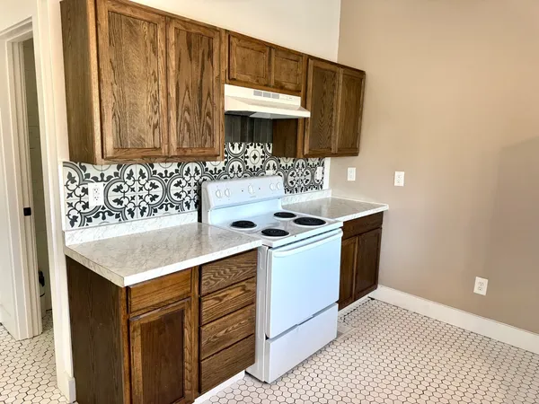 a kitchen with a sink cabinets and a wooden floor