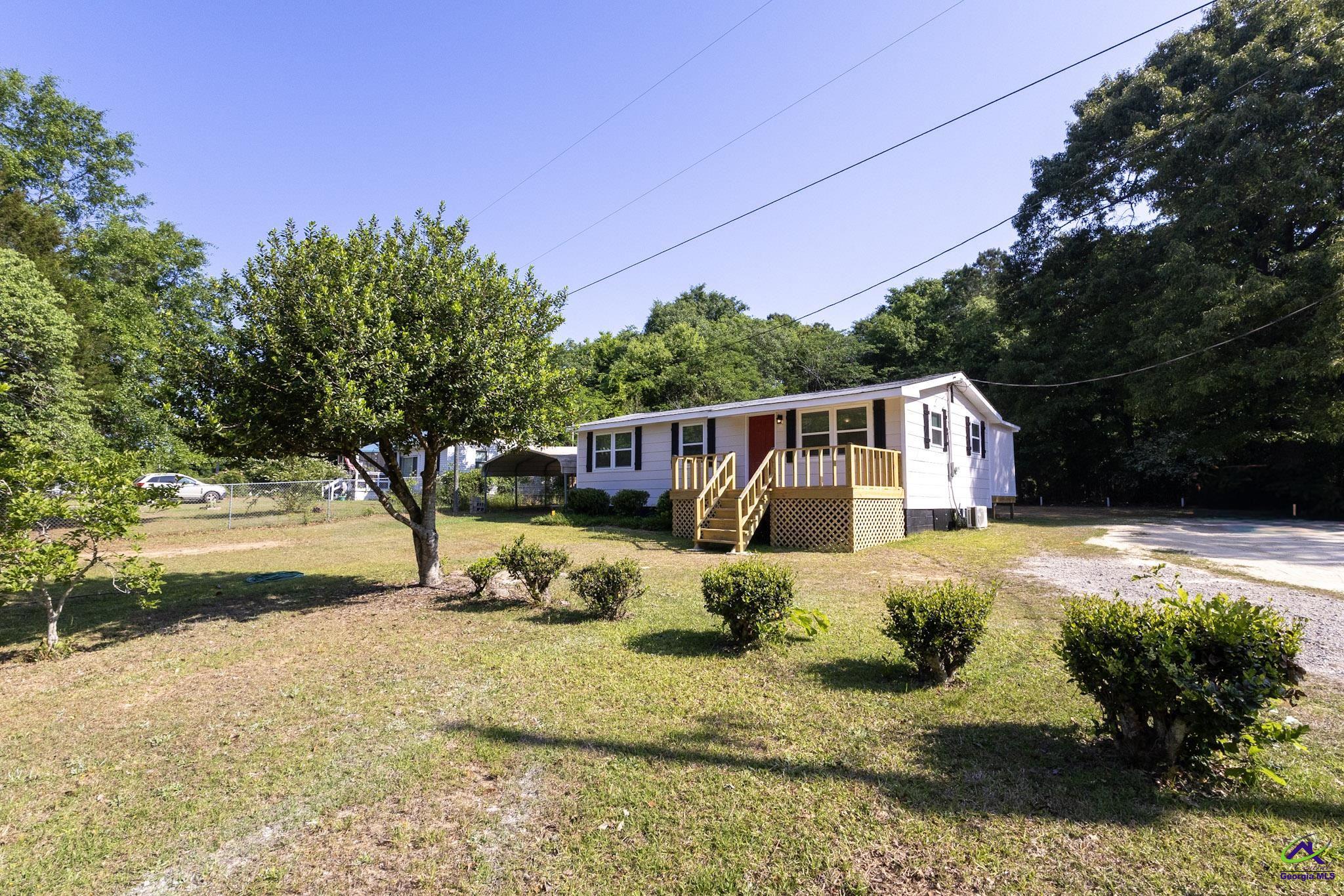 156 Churchwell Road Cochran, GA 31014 - Photo 2 of 20 a view of backyard with swimming pool and seating space
