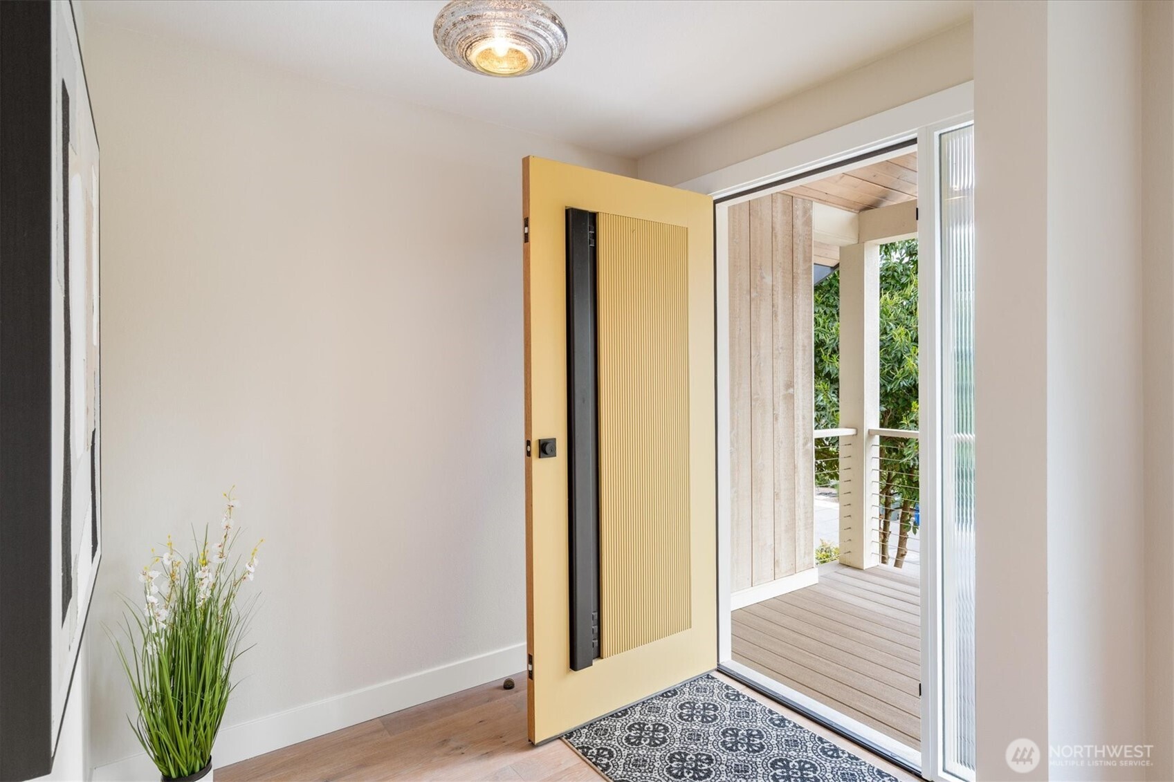 9503 Odin Way Bothell, WA 98011 - Photo 4 of 39 a view of a hallway with wooden floor and a potted plant