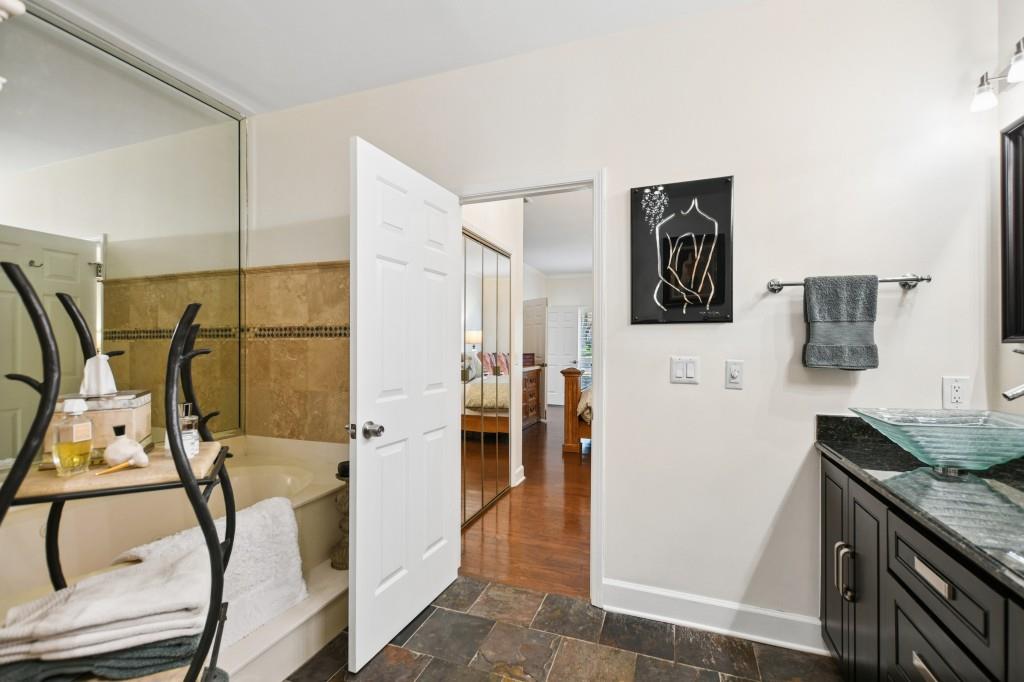 2921 Lenox Road Northeast, Unit 103 Atlanta, GA 30324 - Photo 23 of 37 a bathroom with a sink and mirror