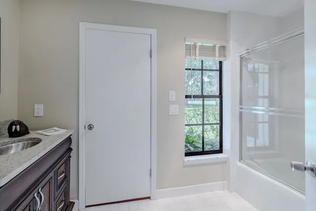 a bathroom with a bathtub sink and mirror