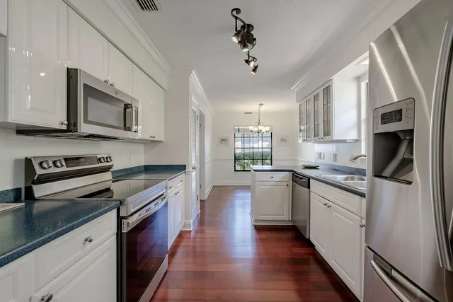 a kitchen with stainless steel appliances granite countertop a stove cabinets and microwave