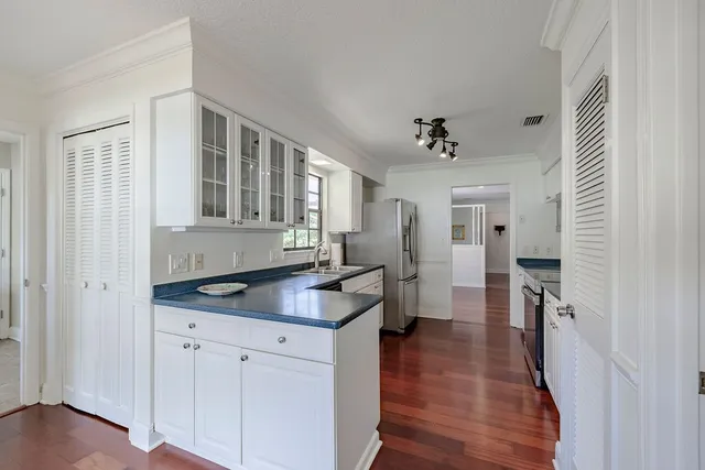 a kitchen with cabinets and wooden floor