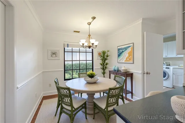 a dining room with furniture a chandelier and wooden floor