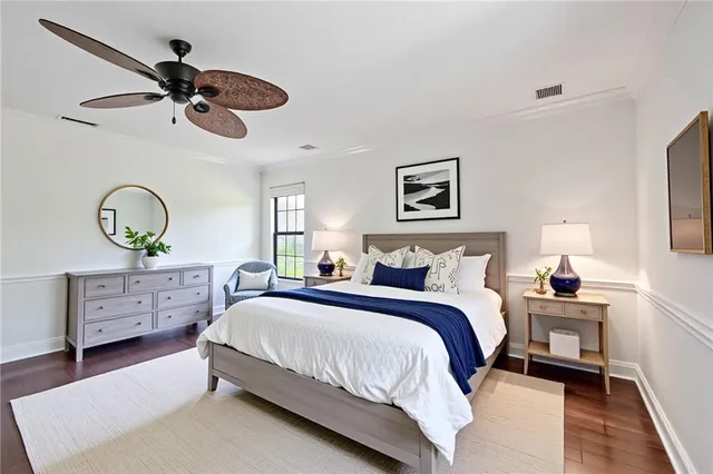 a bedroom with a bed and ceiling fan