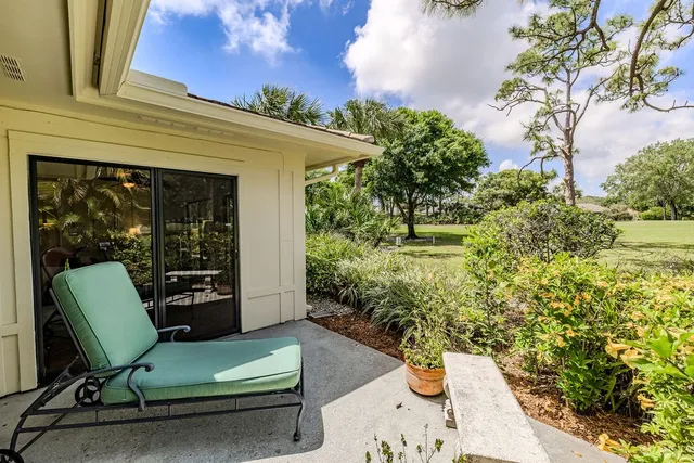 a view of a chair and table in the patio