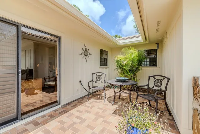 a balcony with table and chairs