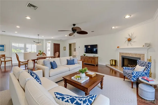 a living room with furniture a fireplace and a flat screen tv