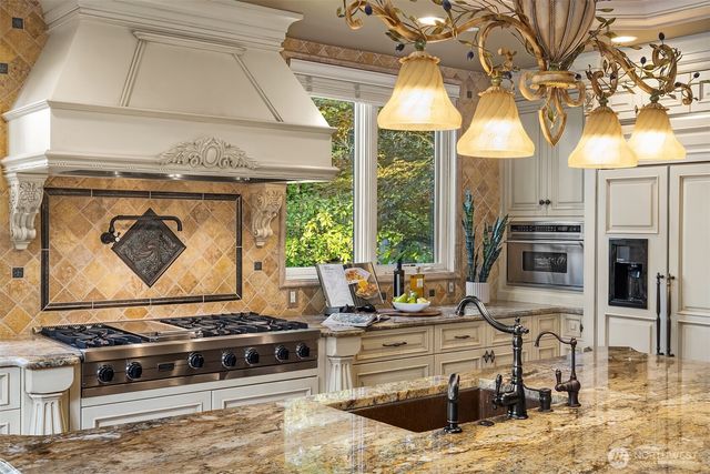 a spacious bathroom with a granite countertop sink a toilet a mirror and vanity