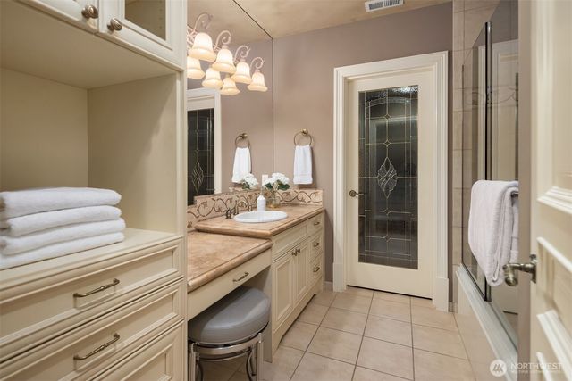 a swimming pool with some potted plants and trees