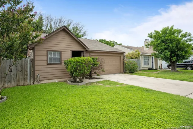a view of a house with a yard and plants