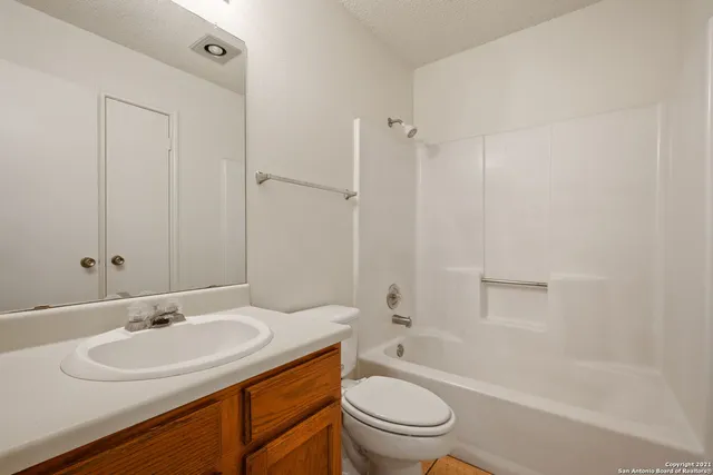 a bathroom with a sink toilet vanity and shower