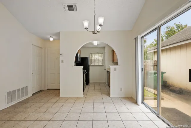 a view of a hallway with a chandelier
