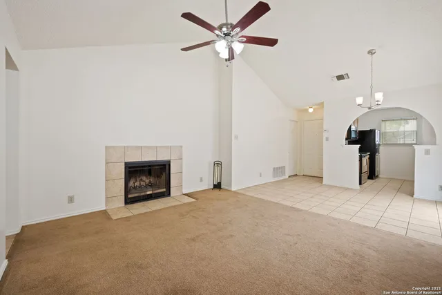 a view of a kitchen with a sink and a fireplace