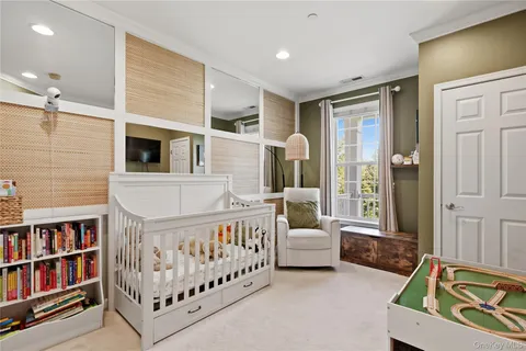 a bedroom with furniture and a book shelf