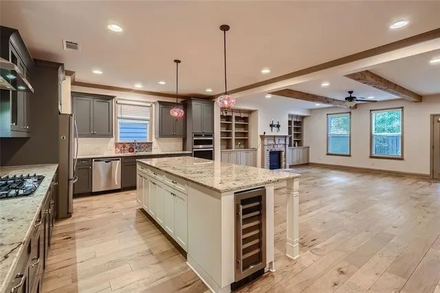 a kitchen with stainless steel appliances granite countertop a stove and a sink