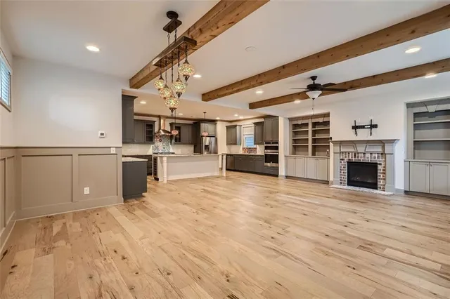 a big room with wooden floors and fireplace