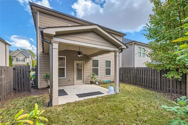 a view of a house with backyard and porch