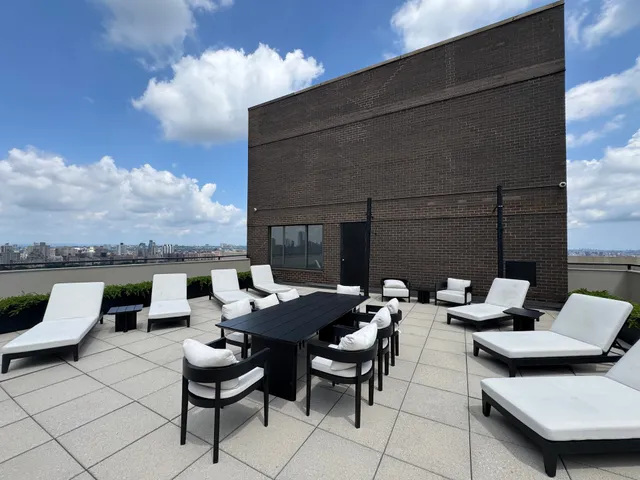 a backyard of a house with fire pit and couch