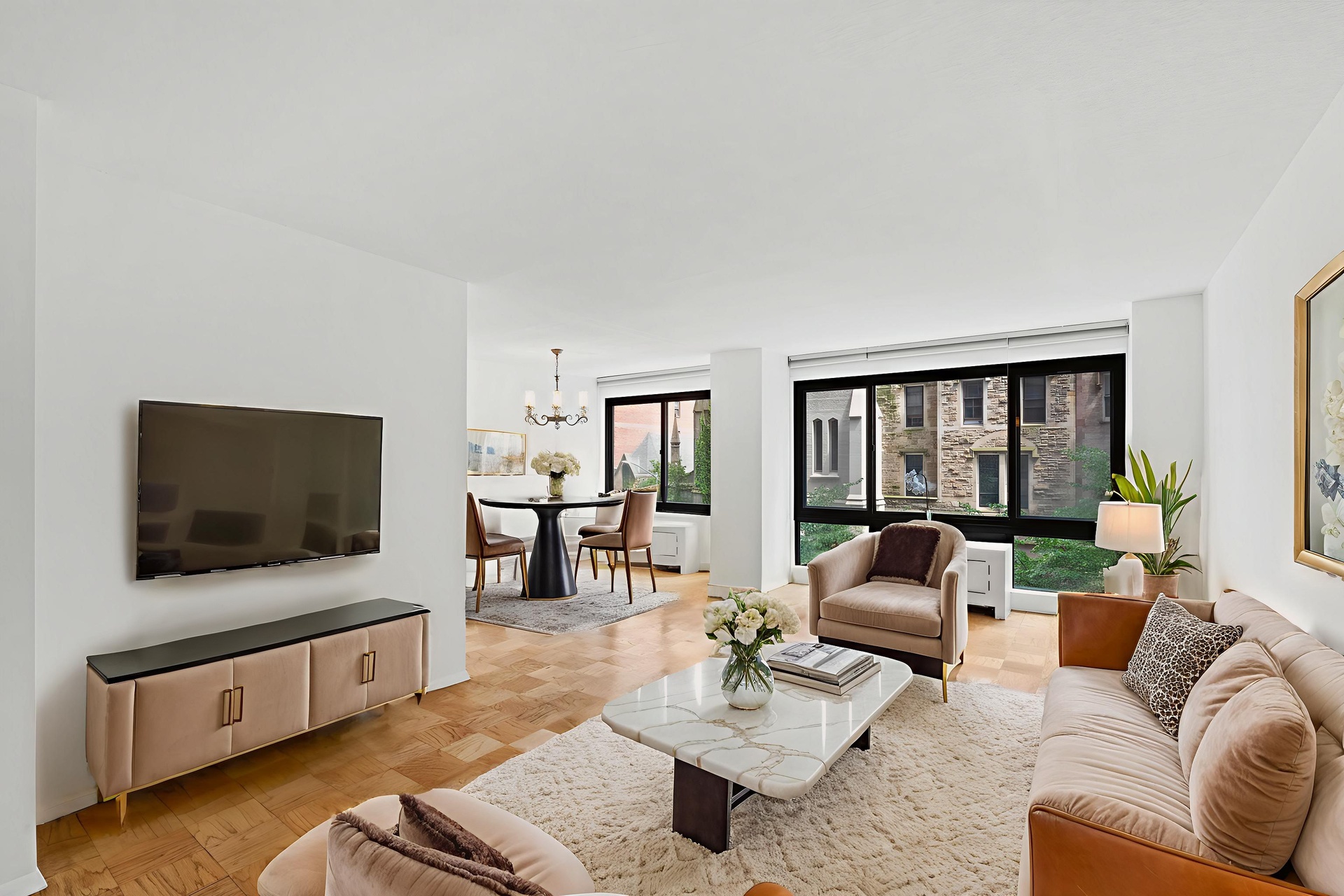 50 East 89th Street, Unit 3C Manhattan, NY 10128 - Photo 2 of 16 a living room with furniture and a flat screen tv
