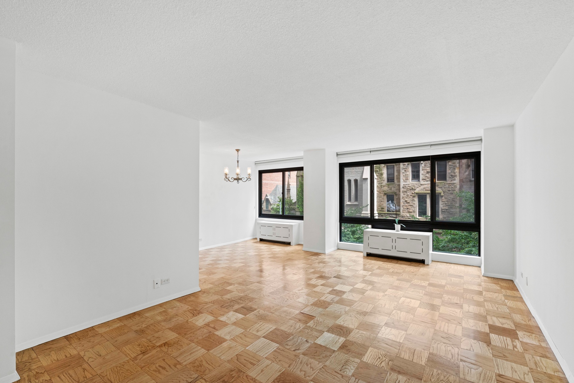 50 East 89th Street, Unit 3C Manhattan, NY 10128 - Photo 3 of 16 a view of empty room with large window