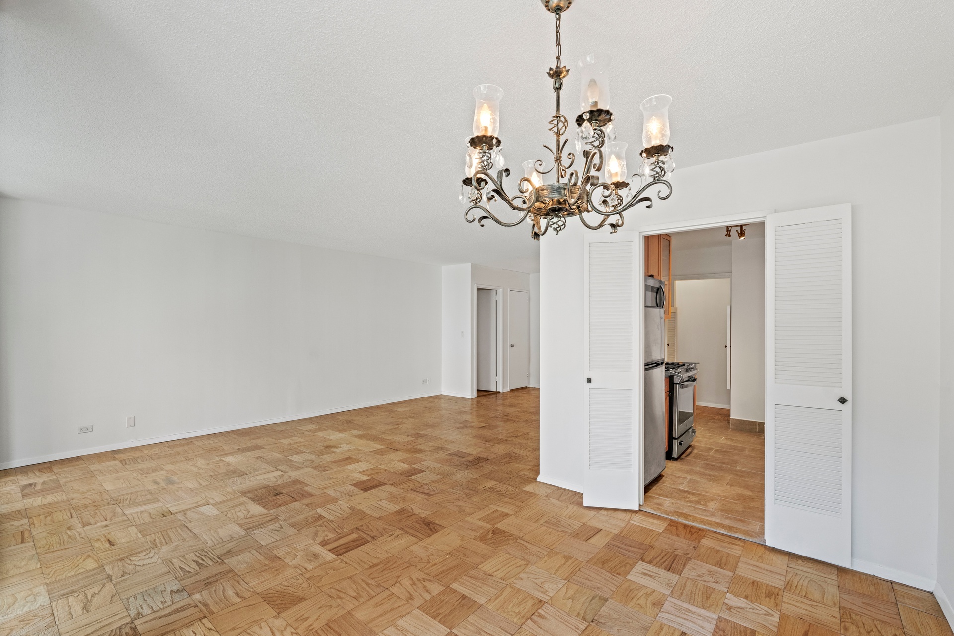 50 East 89th Street, Unit 3C Manhattan, NY 10128 - Photo 4 of 16 a view of a chandelier in big room and chandelier