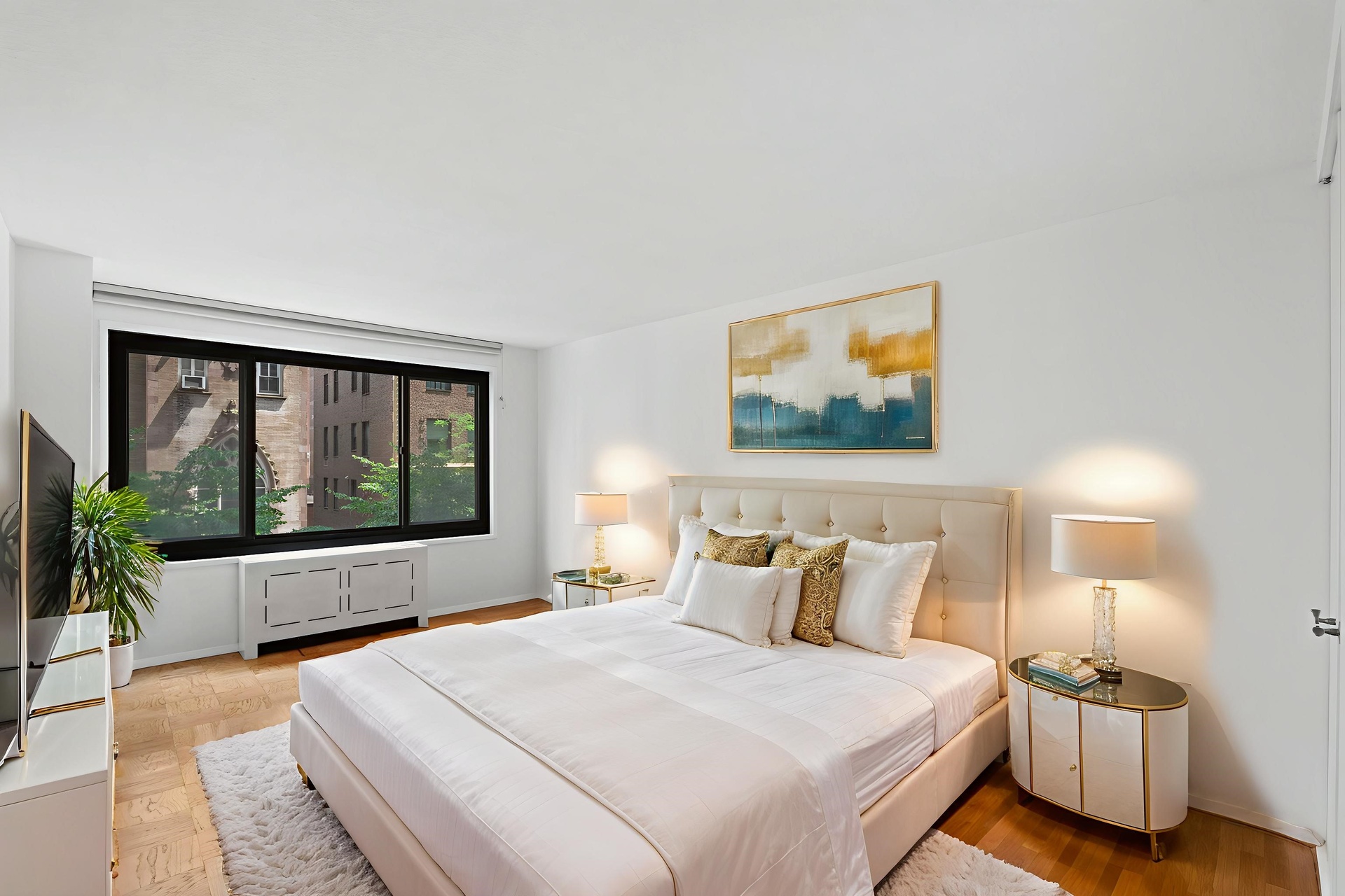 50 East 89th Street, Unit 3C Manhattan, NY 10128 - Photo 5 of 16 a bedroom with a large bed and a large window