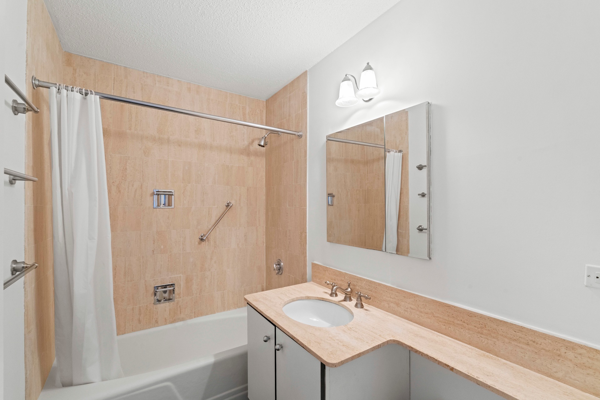 50 East 89th Street, Unit 3C Manhattan, NY 10128 - Photo 7 of 16 a bathroom with a sink tub shower and a mirror