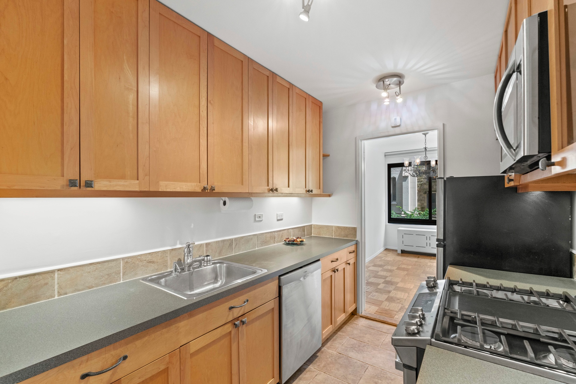 50 East 89th Street, Unit 3C Manhattan, NY 10128 - Photo 8 of 16 a kitchen with a sink and cabinets