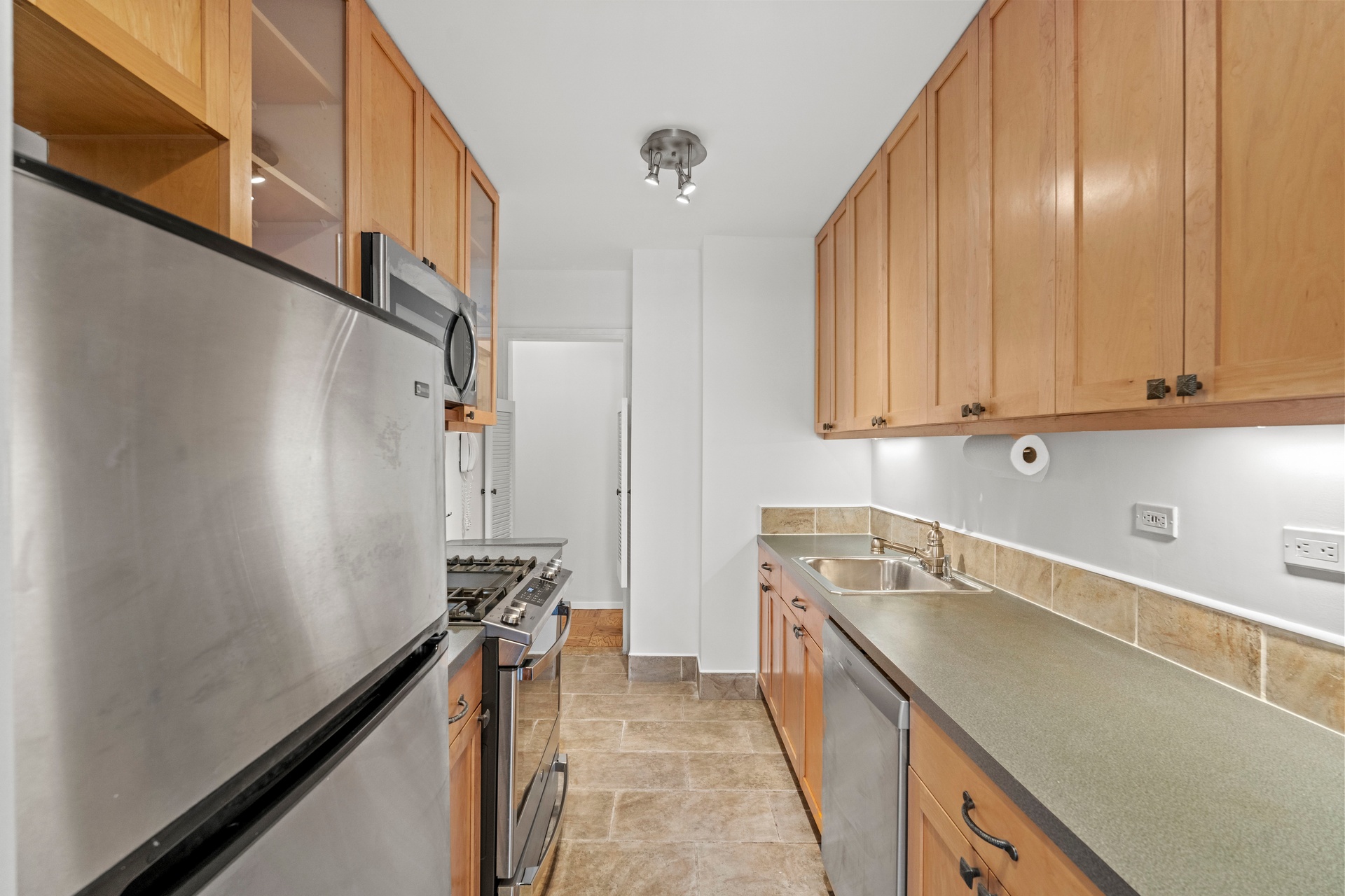 50 East 89th Street, Unit 3C Manhattan, NY 10128 - Photo 9 of 16 a kitchen with a sink and cabinets