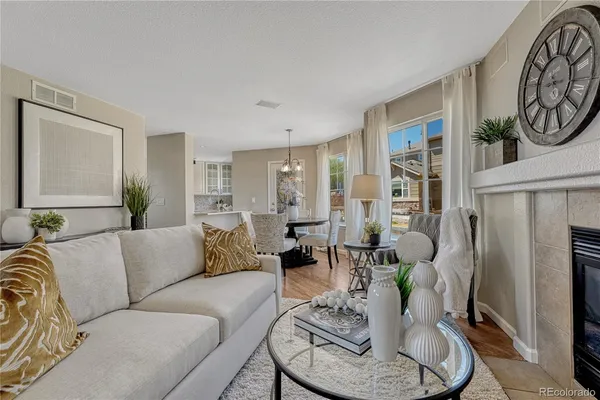 a living room with furniture and a fireplace