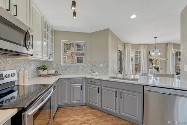 a kitchen with a sink stove and cabinets