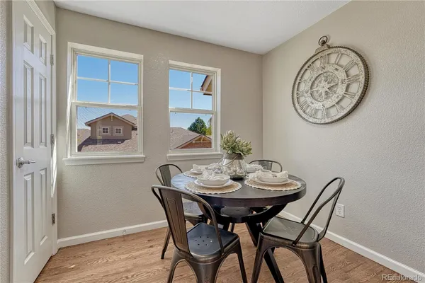 a view of a dining room with furniture and wooden floor