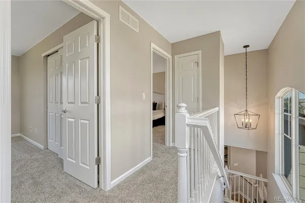 a view of a hallway with a view of living room